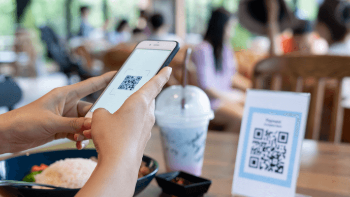A person scanning a QR Code.